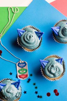 cupcakes with blue frosting and decorations on them