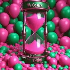 a pink sand clock surrounded by green and pink balls