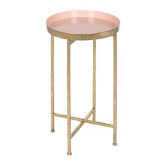 a round table with gold metal legs and pink glass top on an isolated white background