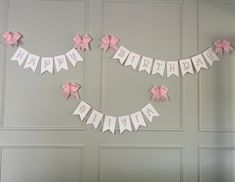 a birthday banner with pink bows on it