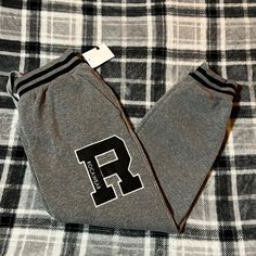 Brand New Never Worn Fall Sports Gray Joggers, Gray Sporty Joggers For Fall, Gray Joggers With Elastic Waistband For Winter, Sporty Gray Joggers For Fall, Gray Letter Print Sweatpants For Leisure, Gray Letter Print Sweatpants For Winter, Gray Letter Print Sweatpants, Gray Athleisure Pants With Letter Print, Gray Joggers With Ribbed Cuffs For Fall