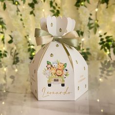 a small white box with animals on it and a ribbon around the top that says lemonade