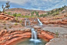 a large waterfall in the middle of a canyon