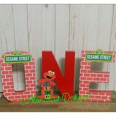 the sesame street letters are made out of wood and have an elm street character on them