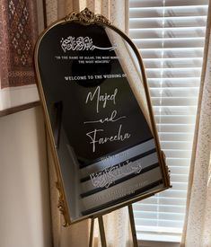 a mirror that is on top of a stand in front of a window with the words welcome to the bride and groom