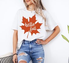 Embrace the cozy vibes of autumn with our "Hello Fall" Shirt, a perfect blend of style and comfort for the season! This adorable fall shirt is designed for women who love to celebrate the season of pumpkin spice, crisp air, and cozy gatherings. Whether you're heading out for a casual day with friends, preparing for Thanksgiving festivities, or simply want to add a touch of autumn to your wardrobe, this shirt has got you covered. Our "Hello Fall" Shirt is not just for women--it's a versatile unis Everyday Fall T-shirt With Letter Print, Everyday Cotton T-shirt For Fall, Relaxed Fit T-shirt For Everyday Fall, Cotton T-shirt For Everyday Fall Wear, Soft-washed T-shirt For Fall, Everyday Fall T-shirt With Graphic Print, Fall Graphic Print T-shirt For Everyday, Everyday Graphic Print T-shirt For Fall, Graphic Print T-shirt For Everyday Fall Wear