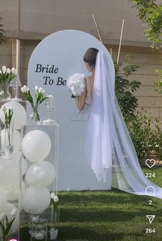 the bride to be sign is surrounded by vases with flowers and balloons in them