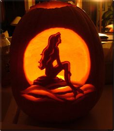 a pumpkin carved to look like a mermaid