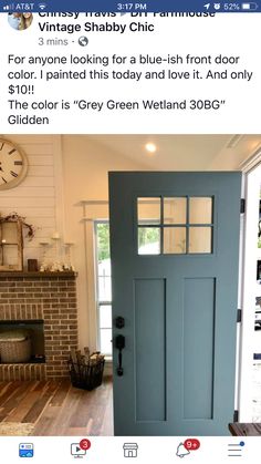 the front door is painted blue with white trim