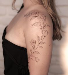 a woman with a tattoo on her shoulder