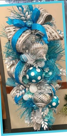 a blue and silver christmas tree with ornaments