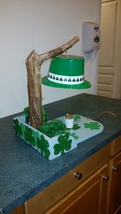 a green hat is sitting on top of a cake in the shape of a tree