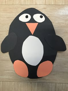 a paper cut out of a penguin with big eyes