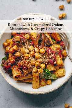 a white bowl filled with pasta covered in sauce and garnished onion, mushrooms, and crispy chickpeas