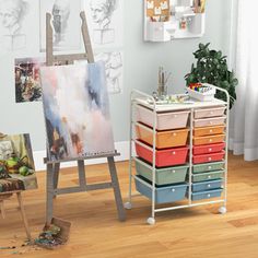 an easel with many drawers and pictures on the wall