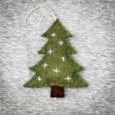 a felt christmas tree ornament hanging on a t - shirt