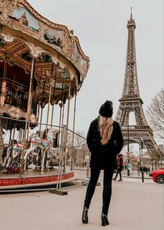 a woman standing in front of the eiffel tower