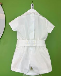 An elegant two-piece set for baby boys to wear during any special occasion. The top has a peter pan collar, handmade pleats, and short sleeves; it has buttons on the back for closure. The bottom is shorts with buttons on the sides for closure, a sash with three pleats, and an elastic band on the back. The interior, or lining, is made with cotton fabric, while the exterior is with white organza. Dry clean 3 piece set Interior: 100% cotton; exterior: 100% polyester Made in Spain Final Sale Fitted Short Sleeve Sets For First Communion, Classic Short Sleeve Sets For Baptism, Baptism Outfits For Boys, Toddler Baptism, White Shorts Outfit, Outfits For Boys, Boy Baptism Outfit, Baptism Outfit, First Communion Dresses