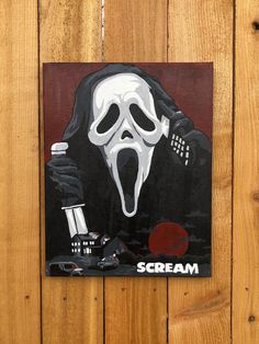 a painting of scream on a wooden wall