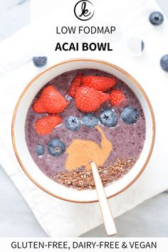 a bowl filled with blueberries and strawberries on top of a white tablecloth