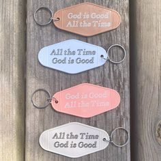 four keychains with the words god is good and all the time on them