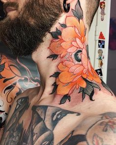 a man with tattoos on his neck and chest is wearing an orange flower tattoo design