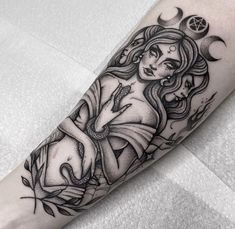 a woman's arm with tattoos on it