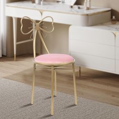 a pink chair with a bow on the back in a white and beige room next to a sink