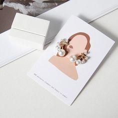 a pair of earrings sitting on top of a card