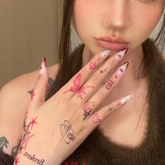 a woman with tattoos holding her hands to her face