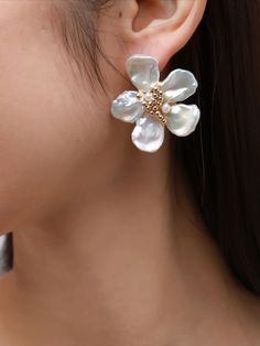 Introducing the COCOKIM Falling Blossoms Series: Petal Earrings. These earrings embody the delicate beauty of falling flower petals in a captivating design. Each earring features intricately crafted petals, delicately arranged to evoke the serene charm of blossoming gardens. The gentle sway of the petals adds movement and grace to your look, while the timeless design ensures versatility for any occasion. Metal: 14K Gold Filled Gemstone: Freshwater Pearl Flowers Diameter: 40mm 3d Flower Shaped Earrings, Feminine Gold Petal Earrings, Elegant Petal-shaped Blossom Jewelry, Flower Cluster Earrings For Wedding, Formal Flower Earrings With Flower Charm, Elegant White Flower Pendant Earrings, Elegant Rose Gold Flower Earrings With 3d Flowers, Elegant Flower Bridal Earrings, Elegant Wedding Flower Earrings