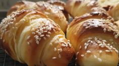 some bread rolls with sesame seeds on them