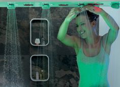 a woman standing in front of a shower head