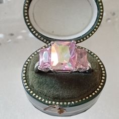 Beautiful iridescent pink crystal dress ring by Kirks Folly. Safely claw set stones set on silver plated mount. Signed inside the band. Kirks Folly made whimsical designs influenced by themes from fantasy and story books. The company folded in 2014 and the pieces have become very sought after. This ring is in very nice condition. Size P and 1/2 (UK sizing) . Presented in eco friendly gift box shown in last photo. All other boxes etc in photos display only. More rings to choose from at  https://g Elegant Iridescent Rings For Parties, Iridescent Sparkling Jewelry As Gift, Iridescent Sparkling Jewelry Gift, Sparkling Iridescent Jewelry As Gift, Sparkling Glamorous Ring For Gift, Sparkling Iridescent Jewelry For Gifts, Sparkling Sterling Silver Crystal Ring Gift, Glamorous Sparkling Ring For Gift, Glamorous Sparkling Gift Ring