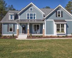 a house with blue siding and white trim on the front door, windows, and shutters