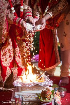 the bride and groom are getting ready to burn their wedding rings on the fire pit