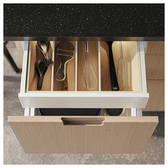 an open drawer with utensils in it