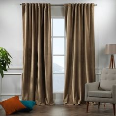 a living room filled with furniture and a window covered in curtains