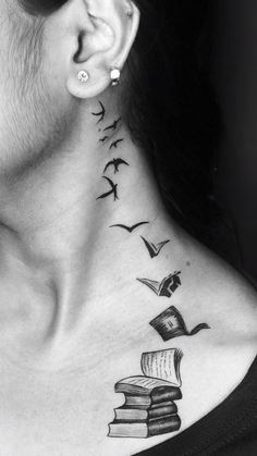 a woman's neck with books and birds tattoo on her left side behind the ear