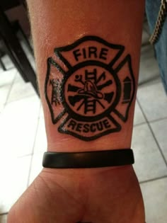 a hand with a fire department tattoo on it