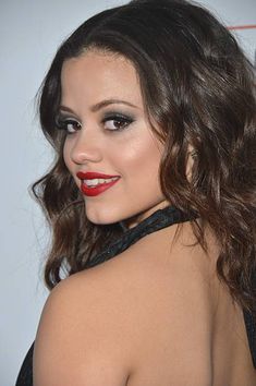 a woman with dark hair and red lipstick