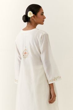 Off white kurta with bead and thread floral embroidery. Paired with a matching embroidered palazzo.
Components: 2
Pattern: Embroidered
Type Of Work: Thread, Sequin
Neckline: V Neck 
Sleeve Type: Three-quarter
Fabric: Silk Chanderi
Color: Off White
Other Details: 
Floral thread and sequin embroidery
Occasion: Puja - Aza Fashions Festive White Tops With Motifs, Festive White Top With Motifs, Festive White Blouse With Motifs, White Tops With Intricate Embroidery For Festive Season, White Intricate Embroidery Festive Top, Festive White Top With Intricate Embroidery, White Embroidered Straight Kurta Blouse, Traditional White Straight Kurta Top, White Cotton Top With Cutdana Details