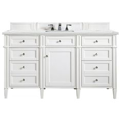 a white bathroom vanity with two sinks and drawers