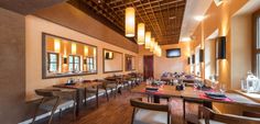 an empty restaurant with wooden tables and chairs