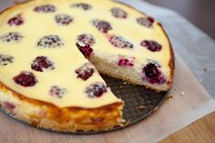 a cheesecake with raspberries is cut into slices