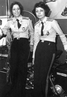 two women in uniform standing next to each other