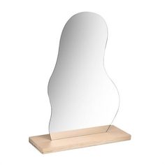 a mirror sitting on top of a wooden stand