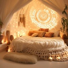 a bed with lights on the wall and pillows in front of it, surrounded by plants