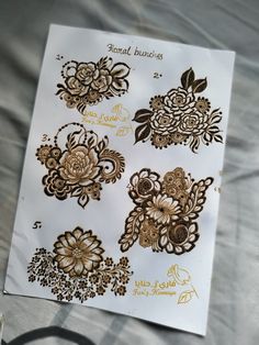 some stickers that are on top of a sheet of paper with gold foil flowers