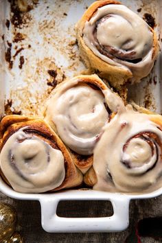 cinnamon rolls with icing in a baking dish